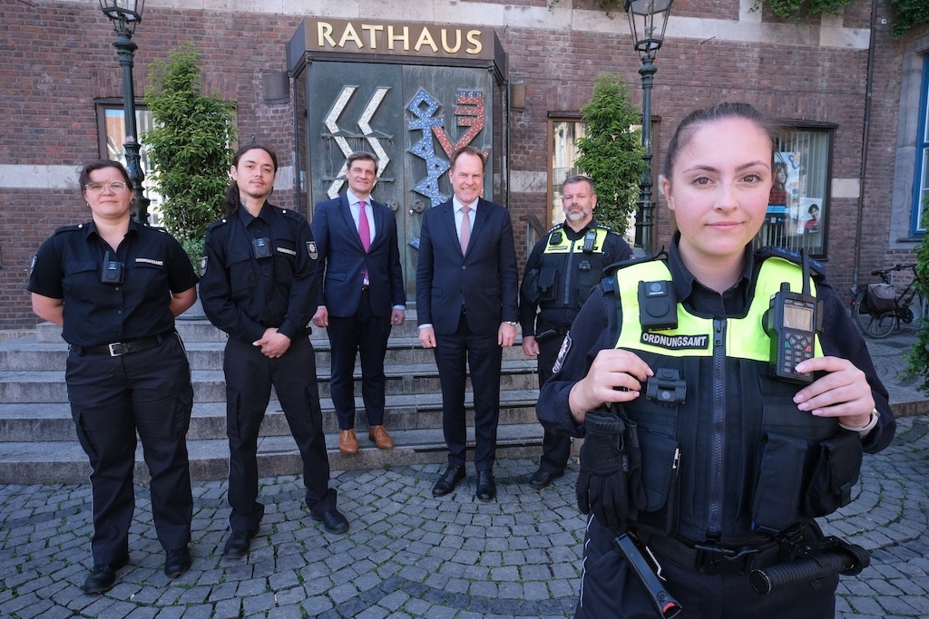 Oberbürgermeister Dr. Stephan Keller (Mitte rechts) und der Ordnungsdezernent Christian Zaum (Mitte links) gemeinsam mit Kräften des OSD und der Vehrkehrsüberwachung. Die Dienstkräfte haben in den vergangenen Wochen die Funktionsweisen der Bodycam-Modelle von Axon, Reveal und Zepcam getestet © Landeshauptstadt Düsseldorf/Michael Gstettenbauer